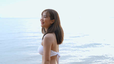 Smiling Young asian woman bikini sexy portrait at seaside beach tropical resting and relaxation...