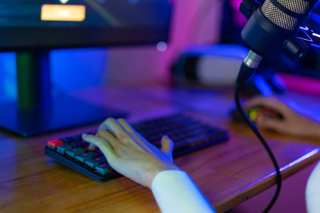 Gamer and E-Sport online of Asian woman playing online computer video game with lighting effect, broadcast streaming live at home. Gamer and E-Sport online gaming technology Championship tournament.の写真素材