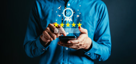 Businessman using smartphone  giving rating 5 stars to guarantee with interface icon tag label for giving the best quality assurance for product or feedback review satisfaction service survey.の写真素材
