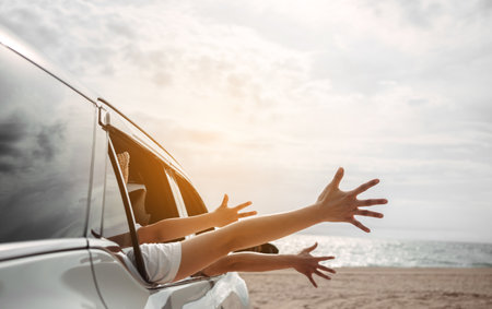 Hatchback Car travel driving road trip of family summer vacation in car at sunset,Girls happy traveling enjoy holidays and relaxation together get the atmosphere and go to destinationの写真素材