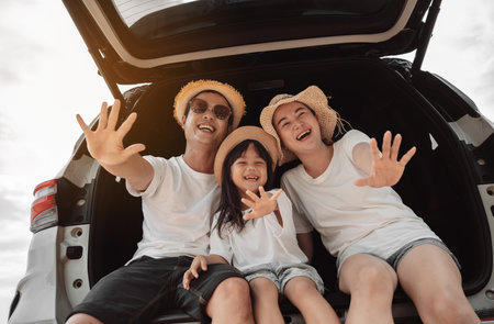 Family with Car travel driving road trip summer vacation in car in the sunset, Dad, mom and daughter happy traveling enjoy holidays and relaxation together get the atmosphere and go to destinationの写真素材