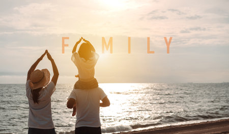 Happy asian family enjoy the sea beach at consisting father, mother and daughter having fun playing beach in summer vacation on the ocean beach. Happy family with vacations time lifestyle concept.の写真素材
