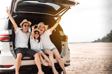 Family with Car travel driving road trip summer vacation in car in the sunset, Dad, mom and daughter happy traveling enjoy holidays and relaxation together get the atmosphere and go to destinationの写真素材