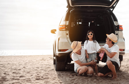 Family travel car road trip concept. summer vacation in car in the sunset, Dad, mom and daughter happy traveling enjoy and relaxation together driving in holidays, people,lifestyle with transportationの写真素材