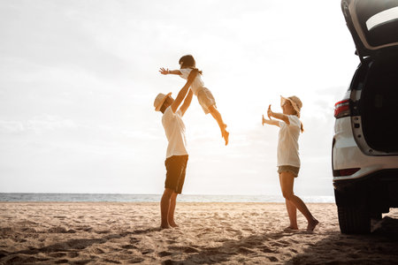 Happy Family with car travel road trip. summer vacation in car in the sunset, Dad, mom and daughter happy traveling enjoy together driving in holidays, people lifestyle ride by automobile.の写真素材