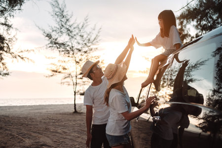Family with Car travel driving road trip summer vacation in car in the sunset, Dad, mom and daughter happy traveling enjoy holidays and relaxation together get the atmosphere and go to destinationの写真素材