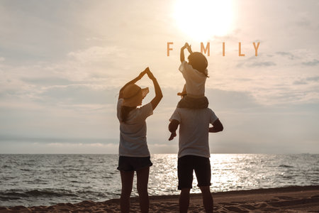 Happy asian family enjoy the sea beach at consisting father, mother and daughter having fun playing beach in summer vacation on the ocean beach. Happy family with vacations time lifestyle concept.の写真素材