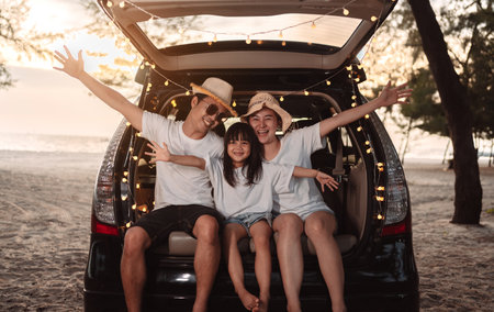 Happy Family with car travel and camping road trip. summer vacation in car in the sunset, Dad, mom and daughter happy traveling enjoy together driving in holidays, people lifestyle ride by automobile.の写真素材