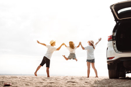 Family travel car road trip concept. summer vacation in car in the sunset, Dad, mom and daughter happy traveling enjoy and relaxation together driving in holidays, people,lifestyle with transportationの写真素材