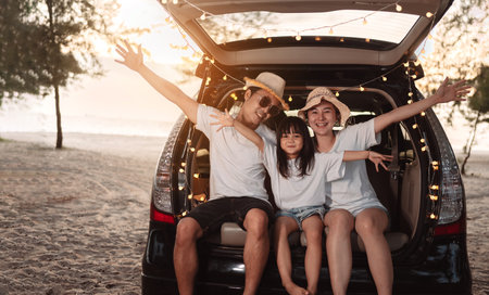 Happy Family with car travel and camping road trip. summer vacation in car in the sunset, Dad, mom and daughter happy traveling enjoy together driving in holidays, people lifestyle ride by automobile.の写真素材