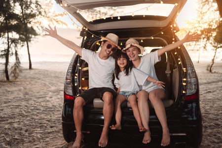 Happy Family with car travel and camping road trip. summer vacation in car in the sunset, Dad, mom and daughter happy traveling enjoy together driving in holidays, people lifestyle ride by automobile.の写真素材