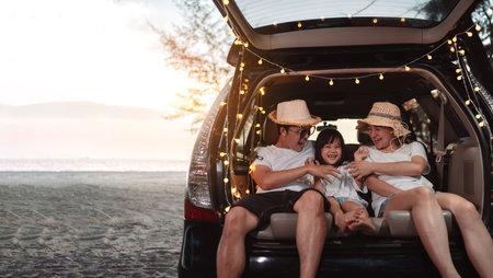 Happy Family with car travel and camping road trip. summer vacation in car in the sunset, Dad, mom and daughter happy traveling enjoy together driving in holidays, people lifestyle ride by automobile.の写真素材