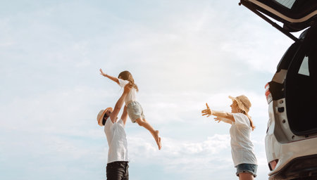 Happy Family with car travel road trip. summer vacation in car in the sunset, Dad, mom and daughter happy traveling enjoy together driving in holidays, people lifestyle ride by automobile.の写真素材