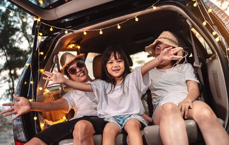 Happy Family with car travel and camping road trip. summer vacation in car in the sunset, Dad, mom and daughter happy traveling enjoy together driving in holidays, people lifestyle ride by automobile.の写真素材