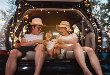 Happy Family with car travel and camping road trip. summer vacation in car in the sunset, Dad, mom and daughter happy traveling enjoy together driving in holidays, people lifestyle ride by automobile.の写真素材