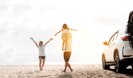 Happy Family with car travel road trip. summer vacation in car in the sunset, Dad, mom and daughter happy traveling enjoy together driving in holidays, people lifestyle ride by automobile.の写真素材