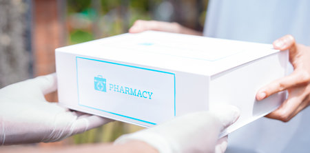 Closeup hands of women patient take covid first aid box self recover health care. customer delivery service from hospital online clinic retail Rx drug store in e-commerce home order.の写真素材