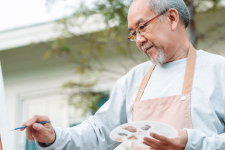Asian caregiver helping senior male from falling on the ground. Older elderly man patient having accident heart attack when physical therapy. Nurse assistance rescue concept.の写真素材