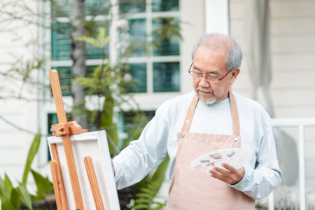 Asian caregiver helping senior male from falling on the ground. Older elderly man patient having accident heart attack when physical therapy. Nurse assistance rescue concept.の写真素材
