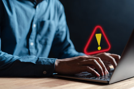 Businessman or it staff , programmer, developer using computer laptop with triangle caution warning...