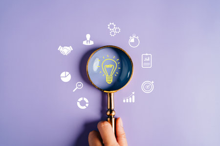 Magnifying glass focus to light bulb icon which for mind, creative, idea, innovation, motivation planning development leadership and customer target group concept.の写真素材