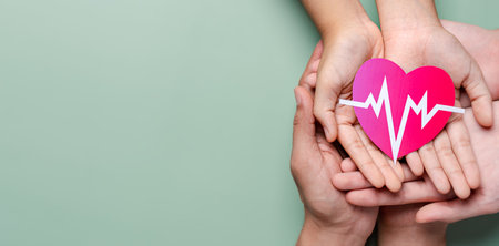 Adult and children hands holding red heart donation with pulse cardiogram, health care, organ donation, family life insurance, world heart day, world health day, praying conceptの写真素材