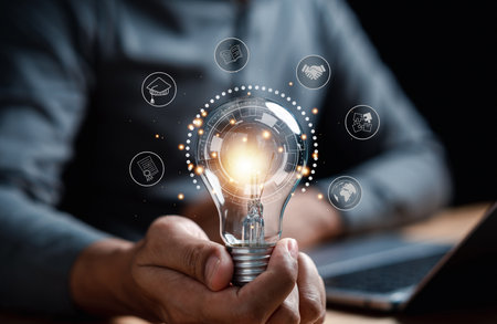 Man hand holding lightbulb with learning educate and graduation concept. study knowledge to creative...