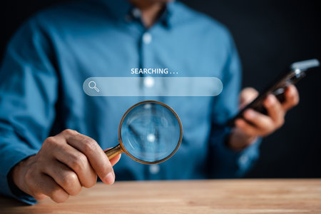 Businessman use magnifying glass Search On Virtual Screen Data Search Technology Search Engine Optimization. Man use computer to Searching for information. Using Search Console for data.の写真素材