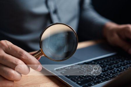 Businessman use magnifying glass Search On Virtual Screen Data Search Technology Search Engine...