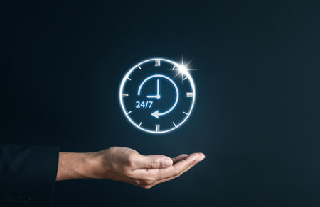 Nonstop service 24 hr concept. businessman hand holding virtual 24/7 with clock on hand for...