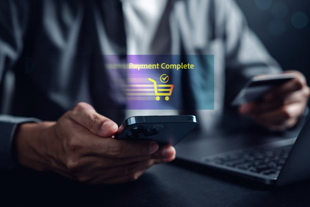 Shopping online payment concept. Man hand using smart phone with cart delivery icon, banking and online shopping via banking mobile app, E-transaction and financial technology.の写真素材