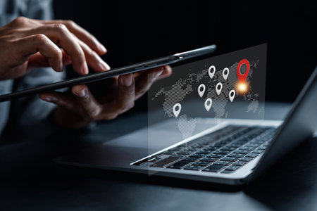 Businessman using smartphone synchronize computer searching world map with location point, GPS app,...