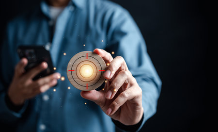 Businessman hand holding target objective icon which for planning development leadership and customer target group concept.の写真素材