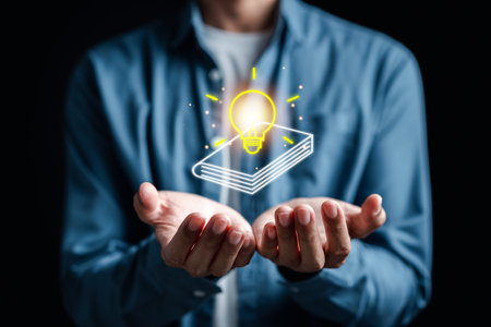 Man hand holding virtual light bulb and book with learning educate. study knowledge to creative...