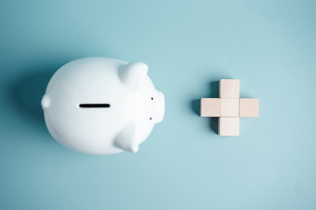 Piggy bank with plus medical icon on wooden cube block. money health check concept. Health care financial checkup and saving for medical insurance cost planning in the future.の写真素材
