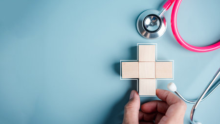 Health insurance concept. people hands putting plus symbol and healthcare medical wooden cube block with icon, health and access to welfare health conceptの写真素材