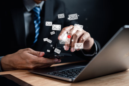 Businessman reading new email by laptop computer to customer, business contact and communication, email icon, email marketing concept, send e-mail or newsletter, online working internet network.の写真素材
