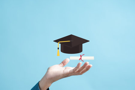 Education leading to success goal graduation. Career path and first for business, Graduation achievement goals concept. Graduation cap on hands.の写真素材
