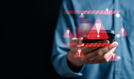 System warning caution sign on smartphone, scam virus attack on firewall for notification error and maintenance. Network security vulnerability, data breach, illegal connection and information danger.の写真素材
