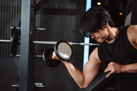 Male working out Bodybuilder with dumbbell weights at the gym.man bodybuilder doing exercises with dumbbell. training sport healthy lifestyle bodybuilding, Athlete builder muscles lifestyle.の写真素材