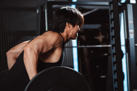 Male working out Bodybuilder with barbell weights at the gym.man bodybuilder doing exercises with barbell. training sport healthy lifestyle bodybuilding, Athlete builder muscles lifestyle.の写真素材