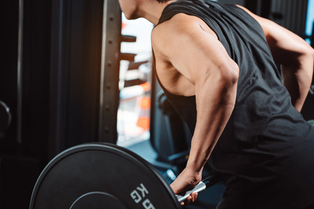 Male working out Bodybuilder with barbell weights at the gym.man bodybuilder doing exercises with barbell. training sport healthy lifestyle bodybuilding, Athlete builder muscles lifestyle.の写真素材