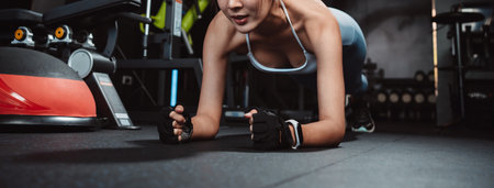 Woman workout or Exercise doing plank at gym workout fitness, athlete muscle building strong healthy lifestyle.の写真素材