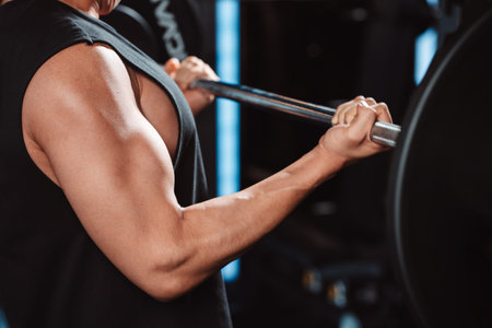 Male working out Bodybuilder with barbell weights at the gym.man bodybuilder doing exercises with barbell. training sport healthy lifestyle bodybuilding, Athlete builder muscles lifestyle.の写真素材