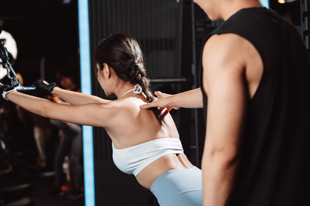 Woman working out Bodybuilder with coaching assistance to support weights at the gym. bodybuilder...