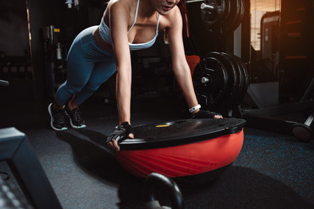 Woman workout or Exercise doing plank at gym workout fitness, athlete muscle building strong healthy lifestyle.の写真素材