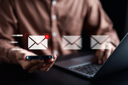 Businessman sending email by laptop computer to customer, business contact and communication, email icon, email marketing concept, send e-mail or newsletter, online working internet network.の写真素材