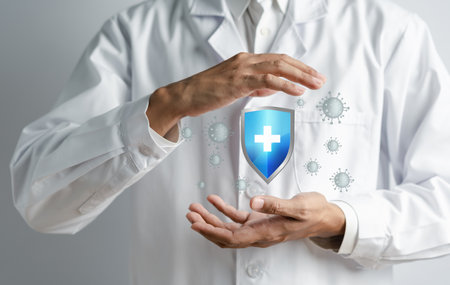 Doctor in a white coat hands holding protection shield anti virus and bacteria, Health care secure concept.の写真素材
