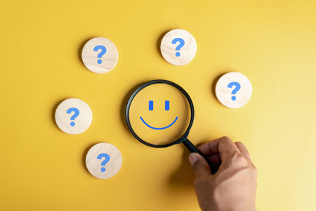 Mental Health check concept. Magnifier focus to happy smile face which among question icon. mental health positive thinking and excellent good feedback satisfaction review by customer.の写真素材