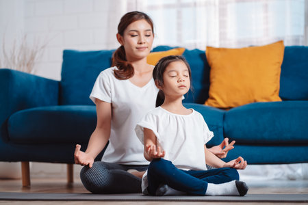 Mother and daughter exercising together happily at home. for flexibility build muscle strength, Sport workout training family together concept.の写真素材